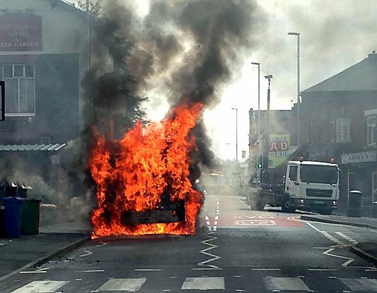 The bus well ablaze on Park Road, Glodwick. 