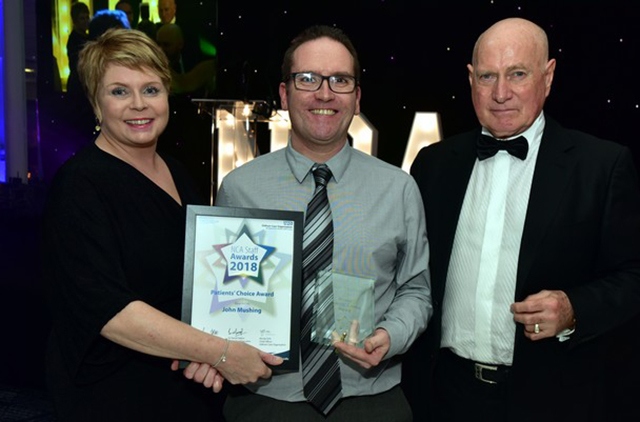 John Mushing, a porter at the Royal Oldham's pharmacy department (centre), receives his Patients’ Choice Award