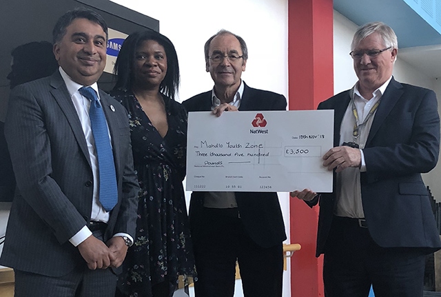 Oldham Business Awards steering group members Kashif Ashraf, Dawn Torrington and Martyn Torr present a cheque to Mike Doran (right), chief executive of Mahdlo