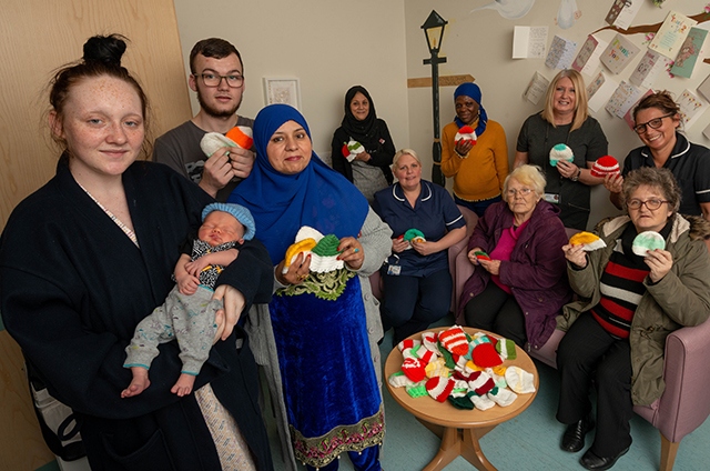 Pictured are baby Reece, mum Stacey Donaldson and dad Dylan Taylor, Hospital staff Melanie Wildman, Lead Midwife at the Labour Ward and Penny McDermott, Ward Manager of the Post-Natal Ward. The ladies from the Knit and Knatter group are Michelle McGahey, Nasra Hampshire, Carol Taylor and Toyibat Ganiyu
