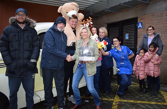 Pictured (left to right) are members of the Rainy City Cruisers hot rod car club with Penny Martin and staff from the Royal Oldham Hospital children’s ward