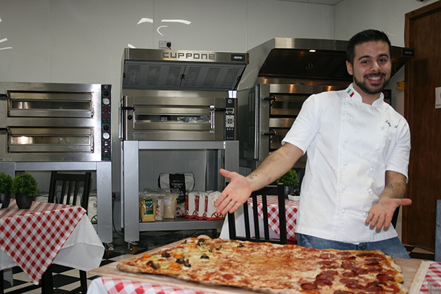 Have a go at the charity Pizza Challenge at Linda Lewis Kitchens' Oldham base. Pictured is chef Fabio Aurelio.