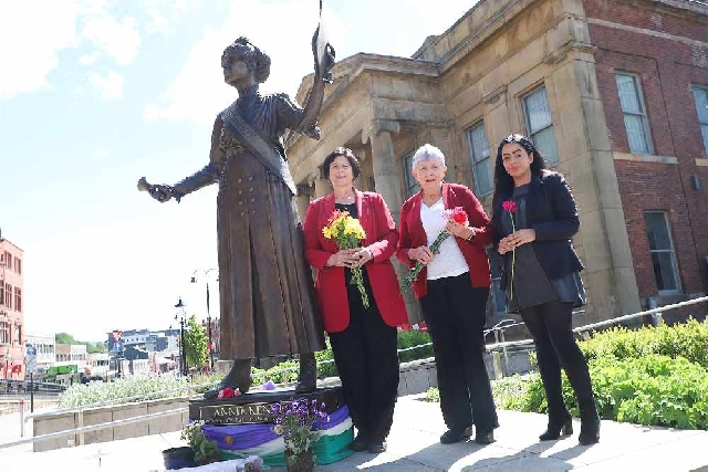 (L-R) Councillors Ginny Alexander, Jenny Harrison and Arooj Shah meeting at the Annie Kenney statue in Oldham town centre earlier today (May 21). 