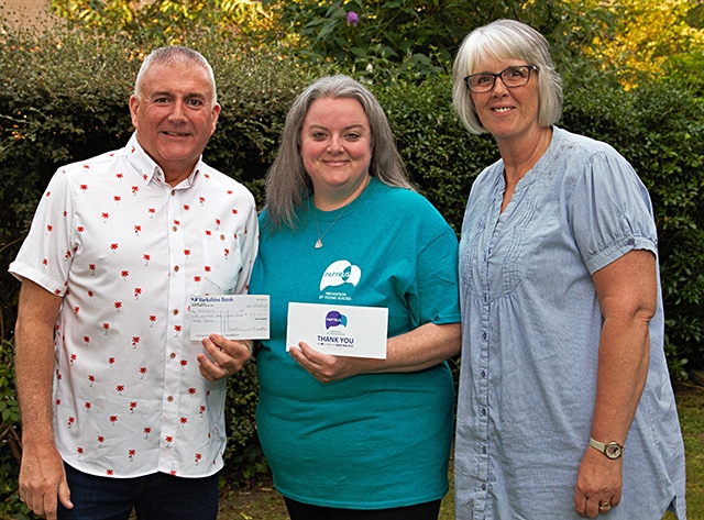 Sarah Fitchett, from Papyrus, receives a cheque from Musical Friends' Paul Osbaldiston and Jayne Collins 