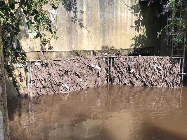 Wet wipes block a sewer overflow at the River Tame in Stockport