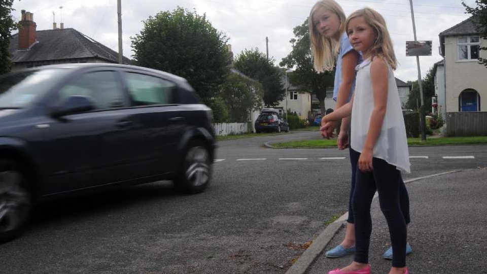 Charlotte and Emily watch a car speed by. Picture courtesy of Rob Lacey     