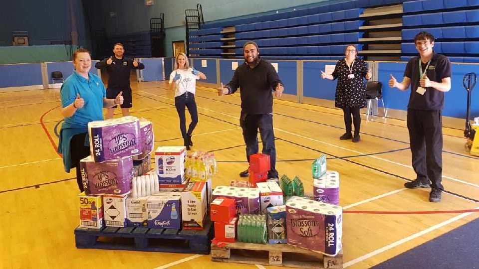 Our picture shows a donation and delivery to Action Together arranged by Ultimate Products' commercial director Jenny Stewart (in white). The drop-off included essential supplies including fabric conditioner, cleaning detergents, shower gels and toothpaste