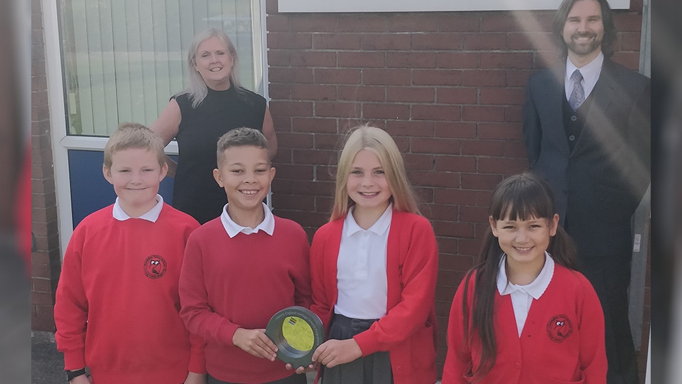 Staff and pupils at Knowsley Junior School with their award