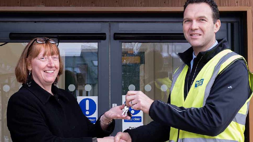 Zoe Thompson, Proprietor and Head of Development, receives the keys to the new Bright Futures School site from Daniel Scott, Operations Director at Robert Scotts