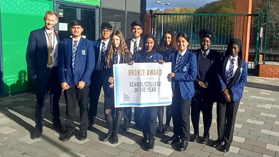 Pictured are Waterhead Academy students celebrating achieving the prestigious bronze award in the UK Social Mobility Awards, within the School/College of the Year category, along with Head of Year 7 Steve Hardy