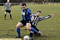 coming through: Avro�s James Hampson feels the force of a challenge from Phil Porter, of Walshaw Sports. 