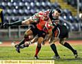 TAKE THAT... a pincer movement spells pain for Oldham�s Marcus St Hilaire. Pictures by GRAHAM LYNCH
