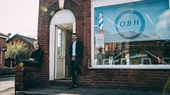 Barber and business owner Darren O'Neill (right) and Jack are pictured outside their Failsworth premises