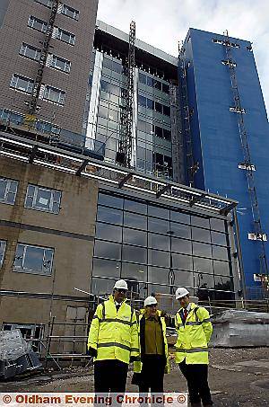 THE 10-storey, 115ft building towering over Oldham Primary Care Trust chairman Riaz Ahmad, Councillor Jackie Stanton, and Ian Entwistle from construction company Carillion. 

Pictures by ANTHONY MILLER 