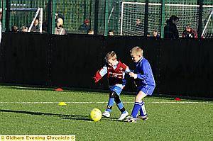 Jack Dunkerley, of Heyside JFC under-nines, surges forward.  