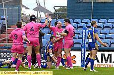 HIGH FIVES: Oldham celebrate a Daryl Cardiss try last night. 