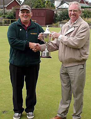 Alan Hodson receives the trophy from Failsworth League President Frank Lees (right). 