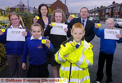 Presentation of fluorescent road safety badges to pupils atb Mather Street School, Failsworth by Oldham Co-operative Funeral Care. Left to right, Shauna Flynn, Teyah Boulding, Vanessa Calverley (Co-op), Alicia Oldham, Nyal Platt, John Walkden (Co-op), Charlotte McGill.