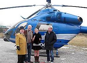 Dropping in on Hollinwood . . . Housing Units’s doorman Fred Waterfield welcomes pilot Brian Kennedy and his colleagues 