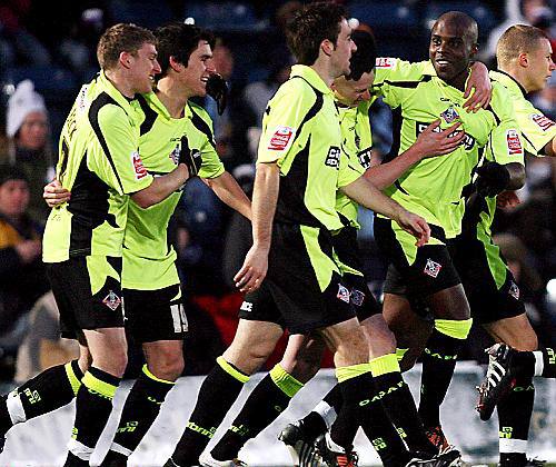 MILES OF SMILES: Reuben Hazell (second right) is congratulated after putting Athletic in front with a second-half header. 