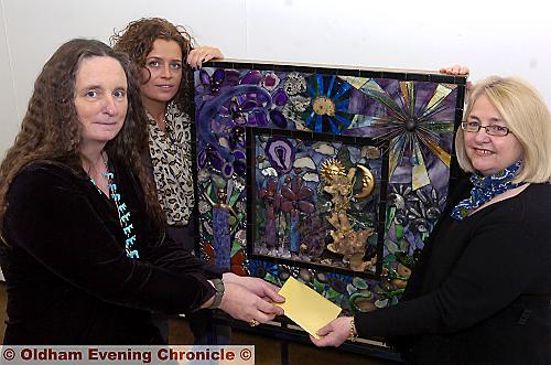 Winning artist Tracey Walshaw (left) accepts her prize from Kate Hancock, from Oldham Arts and Crafts Centre with Joy Thorpe, Oldham Open exhibition curator 