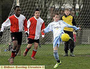 Kain McQuaid, of Failsworth Dynamos under-14s, tries to the hook the ball back into the Ashton United penalty area.