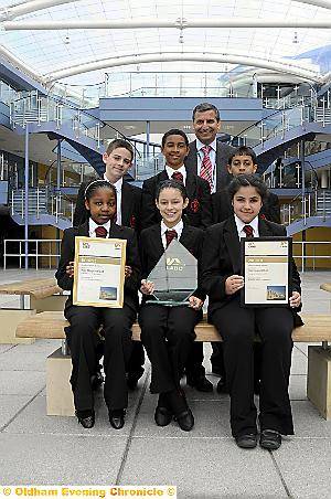 STUNNING school . . . Radclyffe head teacher Hardial Hayer shows off the school’s award with pupils (clockwise, from top left) Daniel Roe, Tyrell Denny, Abdullah Hafeez, Attiyya Rahman, Tia Miller and Cynthia Moyo 
