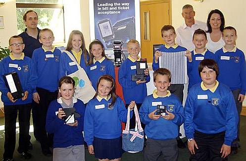 FUTURE business brains . . . Watersheddings Primary School pupils with Councillor Roger Hindle (left) Tony Morrison and teacher Nicola Garth 