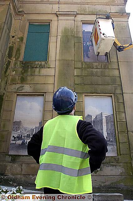 Workmen erect the panels on Oldlam Town Hall. 