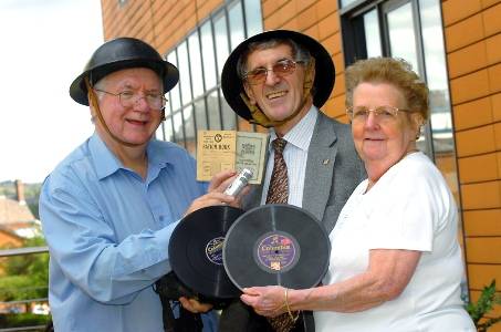 TIN hat time . . . for station manager Dave McGealy with radio station presenters and World War II evacuees Gerry and Barbara Dignan 