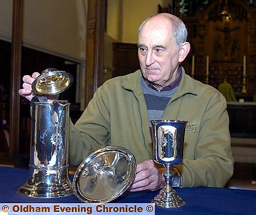 GLEAMING . . . Barry Dainty, churchwarden, with the 18th century silverware