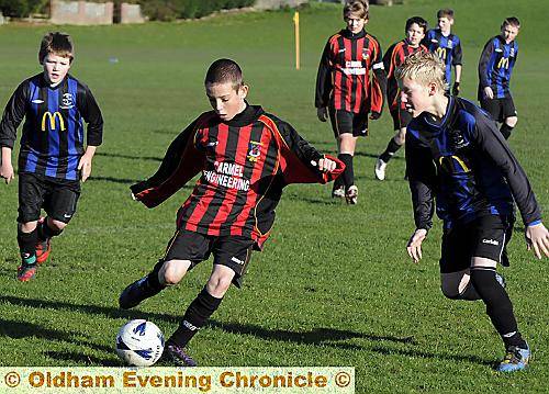 JORDAN Slattery (right), of Heyside, tries to close down Chadderton’s Michael Gill. 