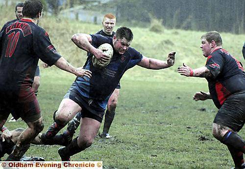 ON the move: Higginshaw’s Dane Armstrong takes on the Cadishead defence. 