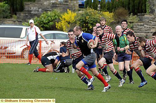 OLDHAM'S Gareth Barber (in blue) breaks away for a try against Aldwinians. 