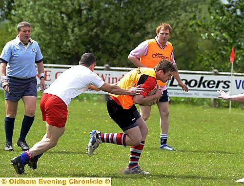 TOUCH AND GO: Gareth Barber’s team (orange bibs), the eventual champions, take on a Jack Taylor team in the Oldham club’s touch rugby competition. 