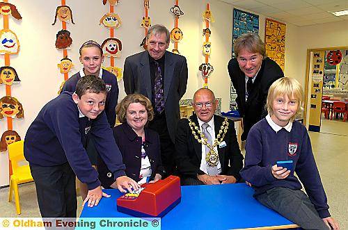 VIP opening . . . Nick Brown, retiring Oldham Sixth Form College principal, back right, gave his seal of approval to the new school when he performed the opening ceremony. With them were (rear, from left) Sophie Gobbi and Roy Butterworth, chairman of governors. Front, from left, Connor Moorfield, head teacher Jane Wilson, the Mayor Councillor David Jones and Ben Stead 
