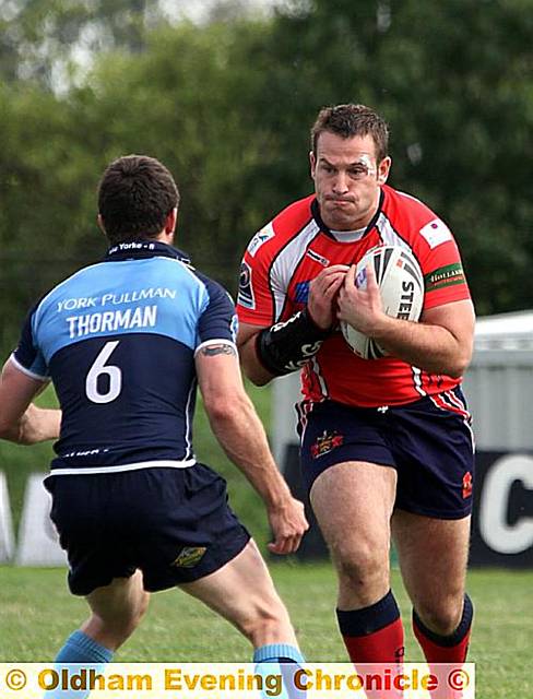 OLDHAM’S Dave Ellison (with ball) runs at York’s Chris Thorman.