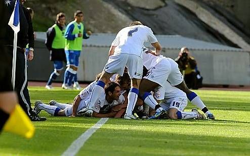 CELEBRATION . . . Lewis Alessandra is buried beneath a sea of Athletic bodies after opening the scoring. 