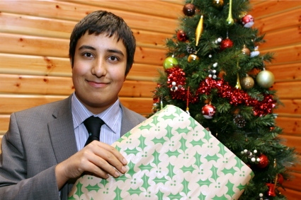 BUSINESS brain . . . Rohin Aojula with his Christmas wrapping paper 
