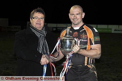 IT’S ALL YOURS . . . Oldham chairman Chris Hamilton hands over the Law Cup to Neil Roden. The long-serving player is the Roughyeds captain for 2011. IT’S ALL YOURS . . . Oldham chairman Chris Hamilton hands over the Law Cup to Neil Roden. The long-serving player is the Roughyeds captain for 2011.