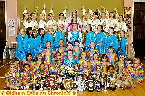 Collettes Dance Troupe pictured with an impressive collection of trophies, including the European Gold Cup 