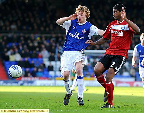 I’M FIRST . . . Athletic winger Chris Taylor holds off Peterborough United full-back Mark Little. 