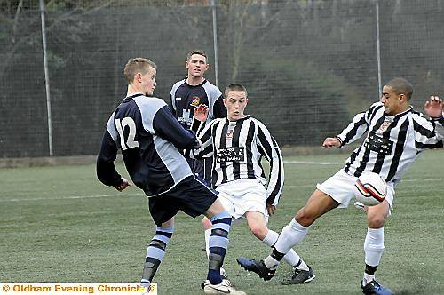 BEST FOOT FORWARD... Gary Chadderton (left), of Hollinwood, competes for the ball with Walshaw’s Luke Chapman and Dominic Slavin. PICTURES by CHRIS SUNDERLAND