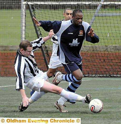 BATTLE... Hollinwood’s Lacola Chembonda (right) is challenged by Walshaw's Brad Pant. PICTURES by CHRIS SUNDERLAND.