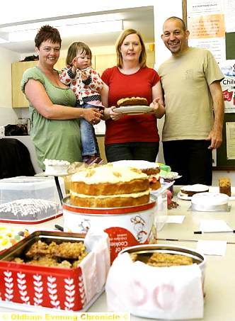 THE cakes lined up and ready for judging with, from left, Jo Chambers, Maddison Worsley (2), Jenny Urlwin-Bishop, and Howard Chambers from Saddleworth Runners 

