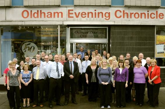 PROUD to serve: Members of the Oldham Evening Chronicle team outside the company offices in Union Street. 