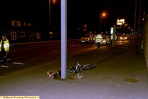 ROAD block... police close Broadway, Chadderton, last night at the scene of the accident 
