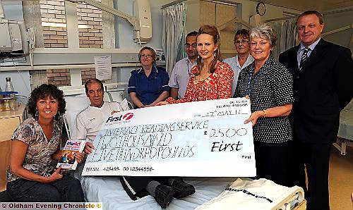 HAPPY to help . . . (from left) reading service co-ordinator Sherry Ormerod, stroke patient Wilfred Larkin, sister Pamela Knowles, consultant Dr Joe Vassalo, former Hollyoaks actress Kathryn George, Adele Ward, ward clerk Sandra Edmondson and Duncan McGraw, from First Buses 
