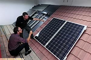 JOHN ELEY (l) and Andy Major on the solar panel mock roof. 