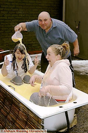 THUMBS-UP from Lisa Pearson (left) as she is doused in custard by Dog and Partridge landlord Nigel Lea, along with Stacey Chatterley 

